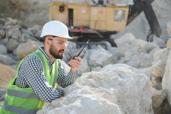 Fotografía de un joven ingeniero hablando por uno de los radios de comunicación para construcción de COMREGIO